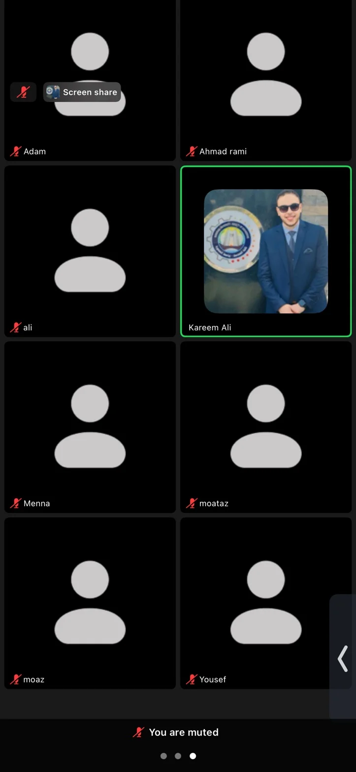 A tutor in a blue suit on a group video call, with other participants shown as avatars.